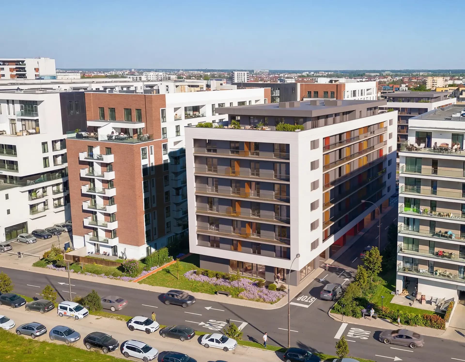 Aerial view of residential buildings along a tree-lined street